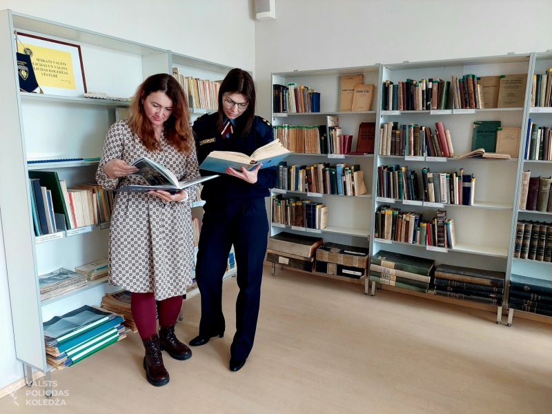 Valsts policijas koledžas direktora vietnieces Anita Fišere un Zane Pumpure Bibliotekā lasa grāmatas